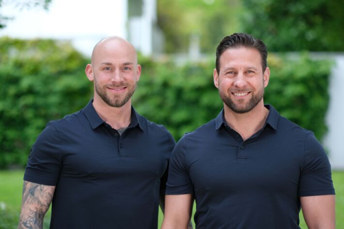 Personaltrainer Julian Schlüter und Christian Blisse, im Freien, Seite an Seite.